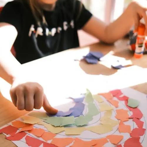 A person making paper art on the table