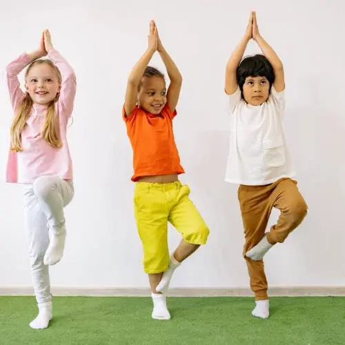 Three children are practicing yoga in a room.